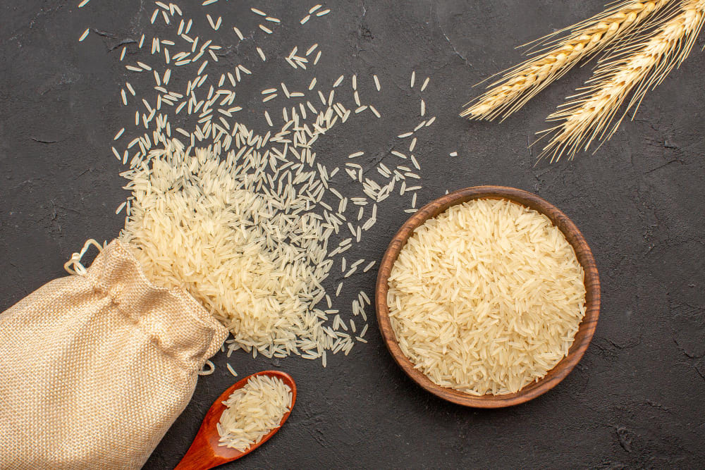 top-view-raw-rice-inside-bag-plate-grey-surface